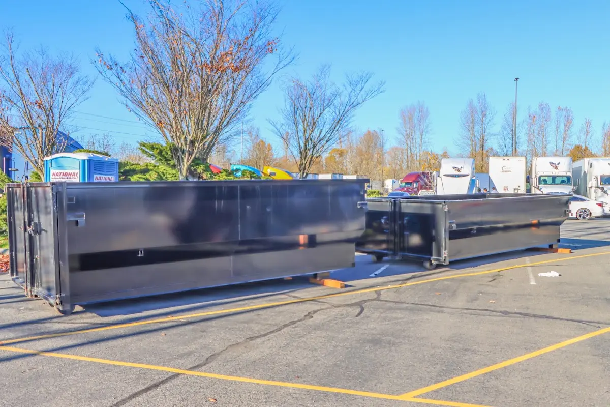 Professional dumpster rental service with roll-off container on residential driveway in Fort Leonard Wood